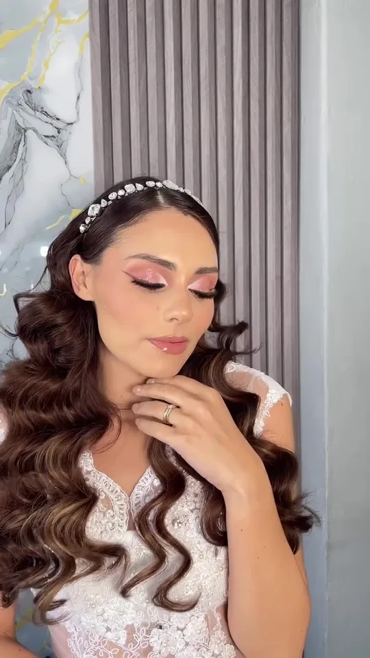 Novia con ondas largas definidas, tiara de cristales y maquillaje en tonos rosados, realizado en el estudio